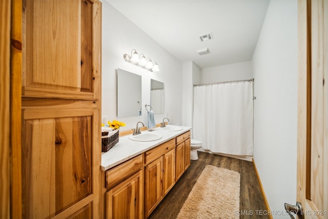 bathroom with a shower with shower curtain, toilet, hardwood / wood-style flooring, and vanity