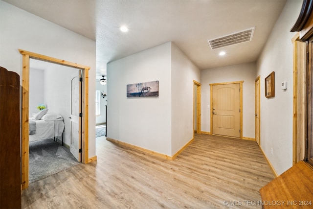 hall with light hardwood / wood-style floors