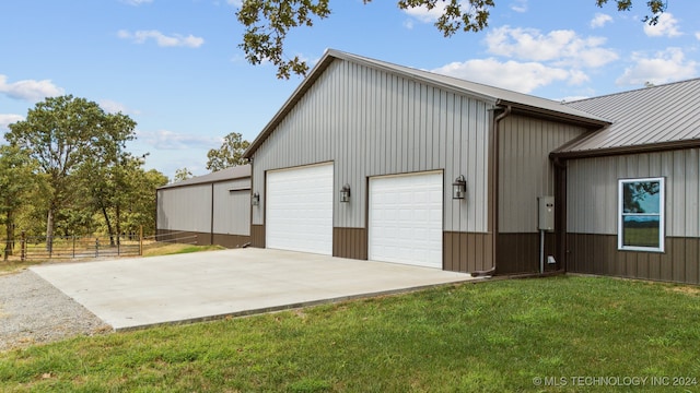 view of outdoor structure featuring a garage and a lawn