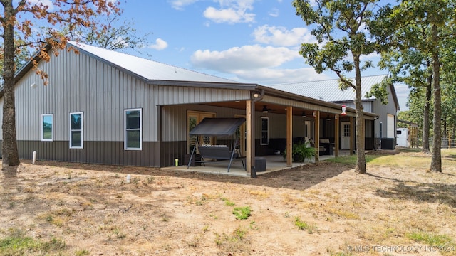 rear view of property featuring central AC, ceiling fan, and a patio area