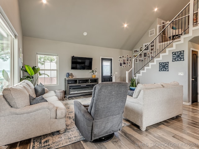 living room featuring hardwood / wood-style flooring and high vaulted ceiling