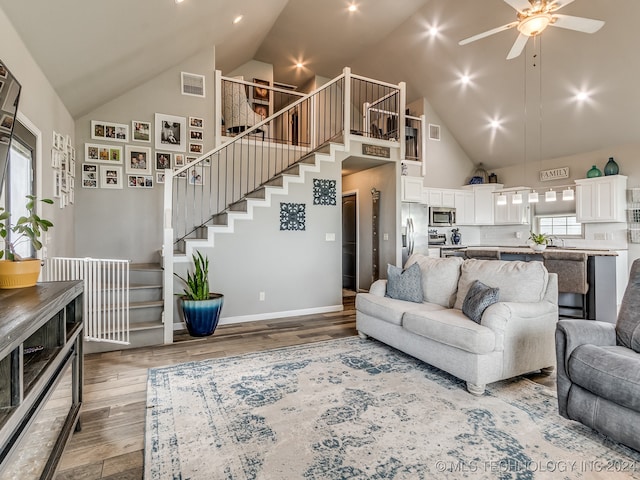 living room featuring hardwood / wood-style floors, high vaulted ceiling, and a wealth of natural light