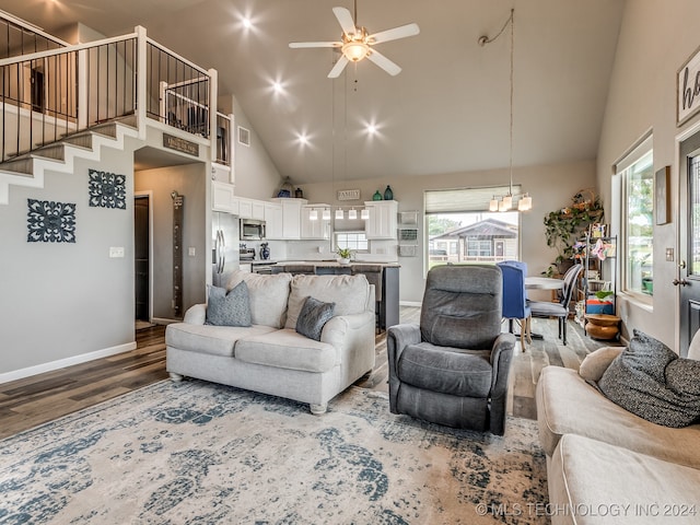 living room with hardwood / wood-style flooring, high vaulted ceiling, plenty of natural light, and ceiling fan