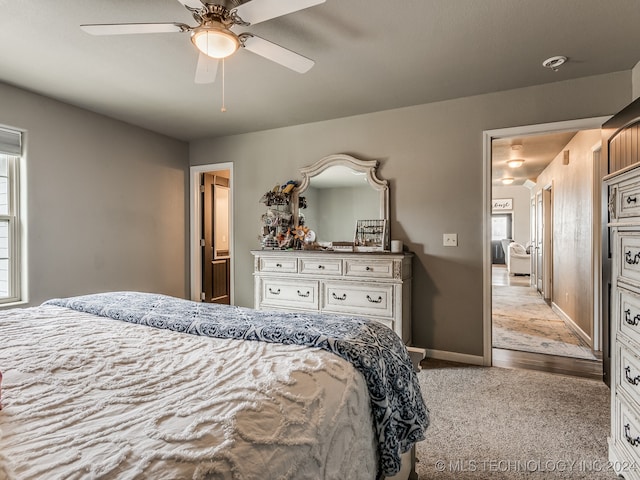 bedroom featuring light colored carpet and ceiling fan