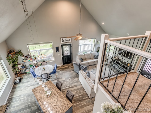 living room with high vaulted ceiling, dark wood-type flooring, and ceiling fan