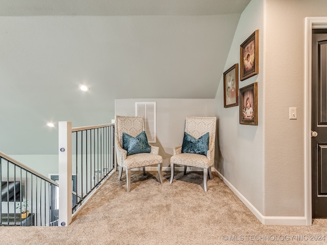 sitting room featuring light carpet and lofted ceiling