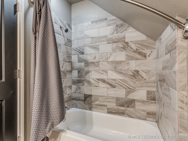 bathroom featuring shower / tub combo with curtain