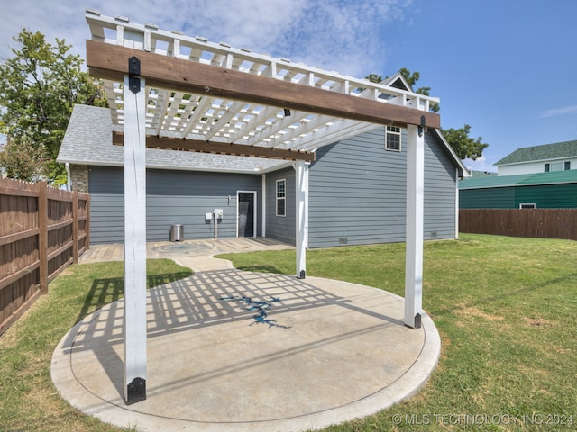 rear view of house with a patio, a pergola, and a lawn