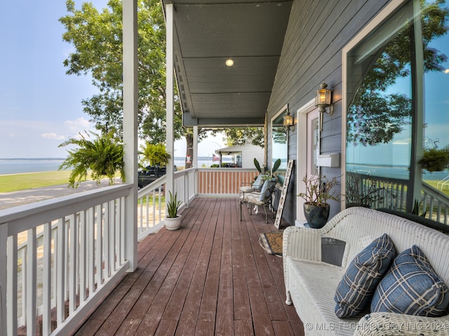 wooden terrace featuring a water view