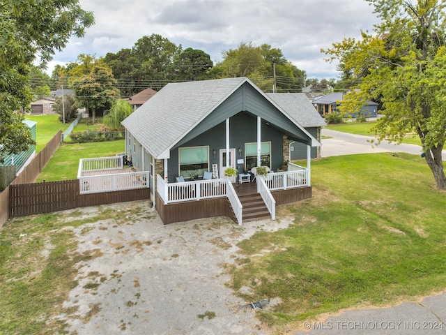 view of front facade featuring covered porch and a front yard