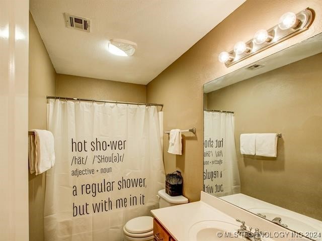 bathroom with vanity, toilet, and a shower with shower curtain