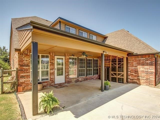 rear view of property featuring a patio and ceiling fan