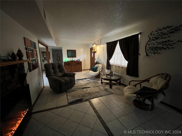 tiled living room featuring a textured ceiling