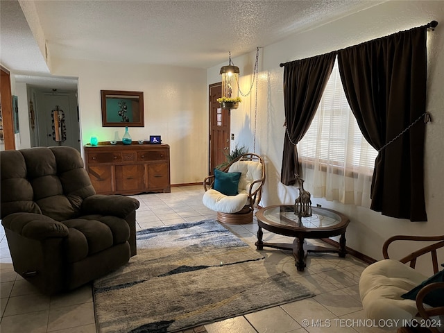 living room with light tile patterned floors and a textured ceiling