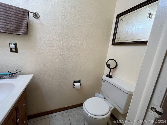 bathroom with vanity, toilet, and tile patterned floors