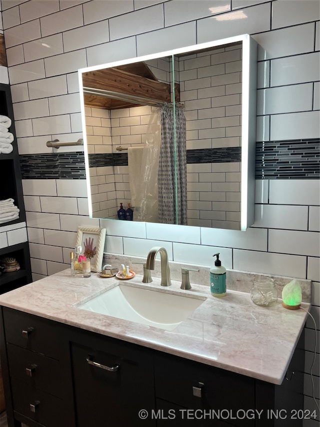 bathroom featuring tile walls, walk in shower, tasteful backsplash, and vanity