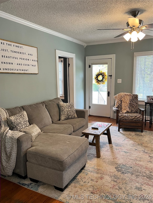 living room with plenty of natural light, ceiling fan, ornamental molding, and hardwood / wood-style floors