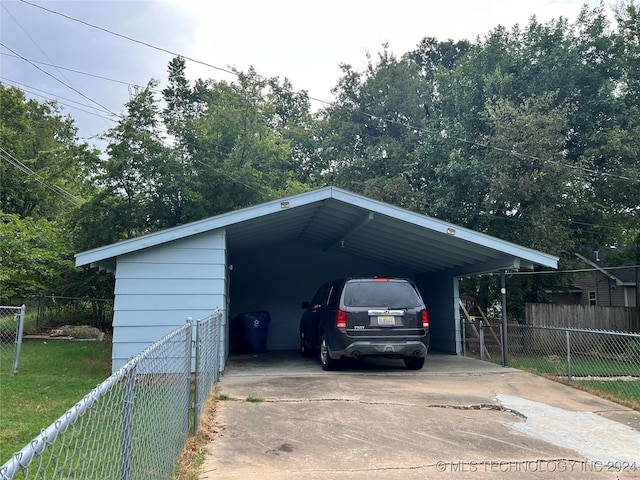 view of parking featuring a yard and a carport