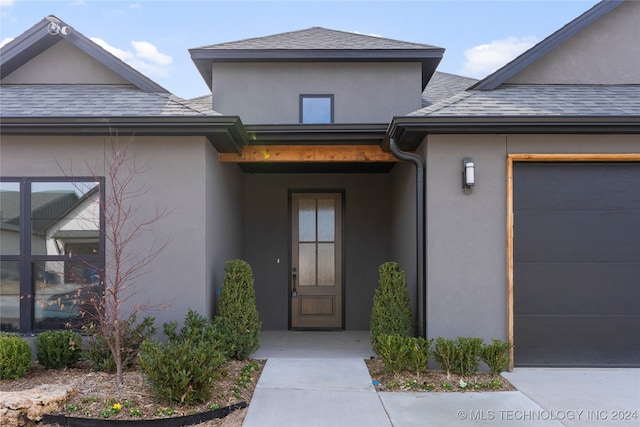 doorway to property featuring a garage