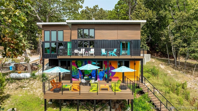 rear view of property featuring a deck