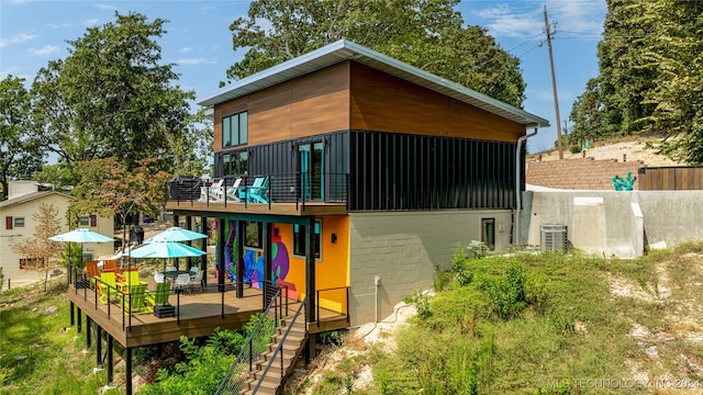 rear view of house featuring a deck and central air condition unit