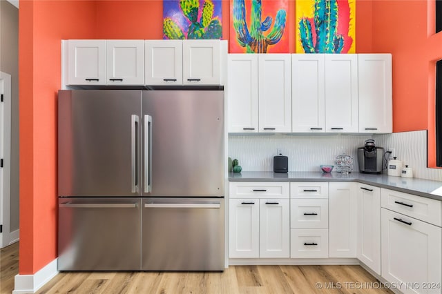 kitchen featuring white cabinets, stainless steel fridge, and light hardwood / wood-style flooring