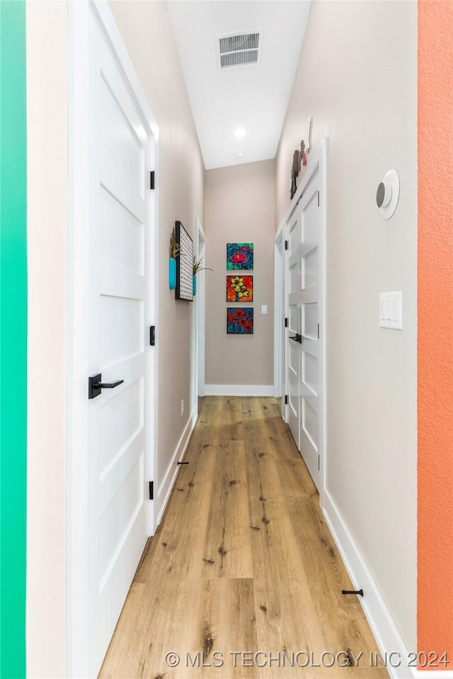 corridor featuring light hardwood / wood-style flooring