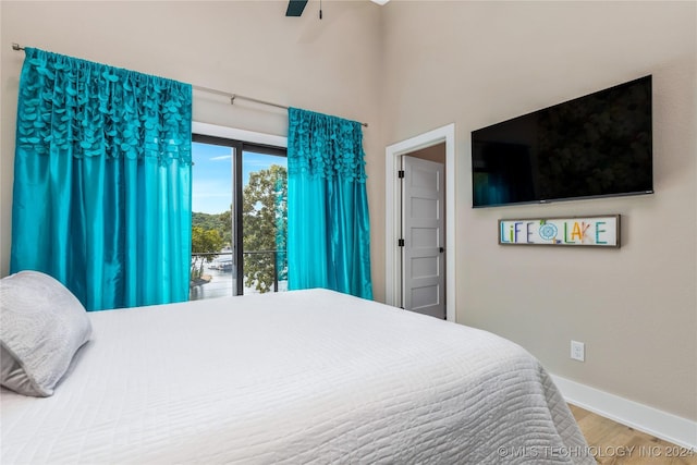 bedroom featuring hardwood / wood-style floors, access to outside, and ceiling fan