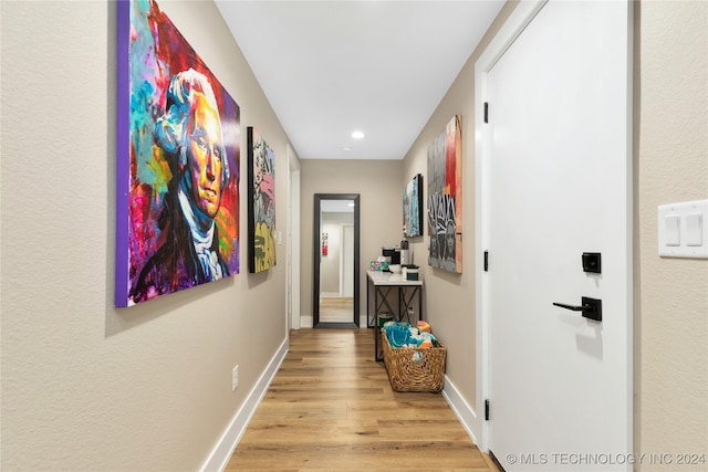 corridor with light hardwood / wood-style flooring