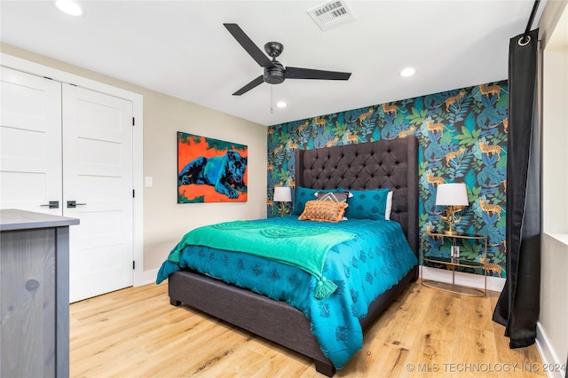 bedroom with ceiling fan and light wood-type flooring