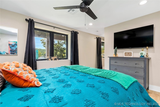 bedroom with wood-type flooring and ceiling fan