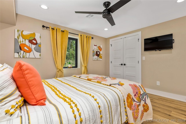 bedroom with hardwood / wood-style floors, a closet, and ceiling fan