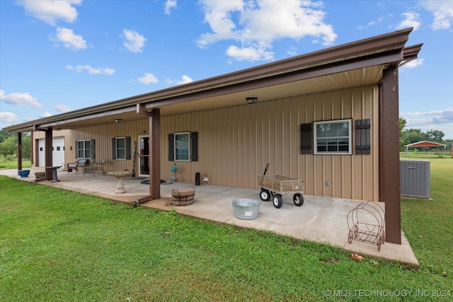 back of property featuring a patio area and a yard