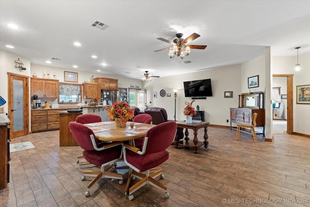 dining room featuring hardwood / wood-style floors, a ceiling fan, visible vents, baseboards, and recessed lighting