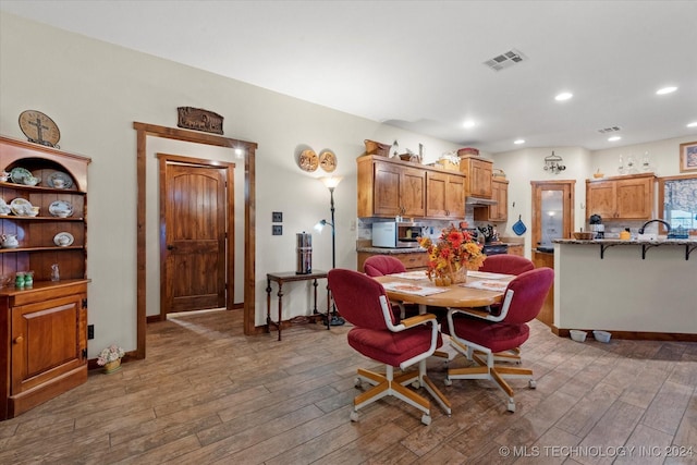 dining room featuring recessed lighting, wood finished floors, visible vents, and baseboards