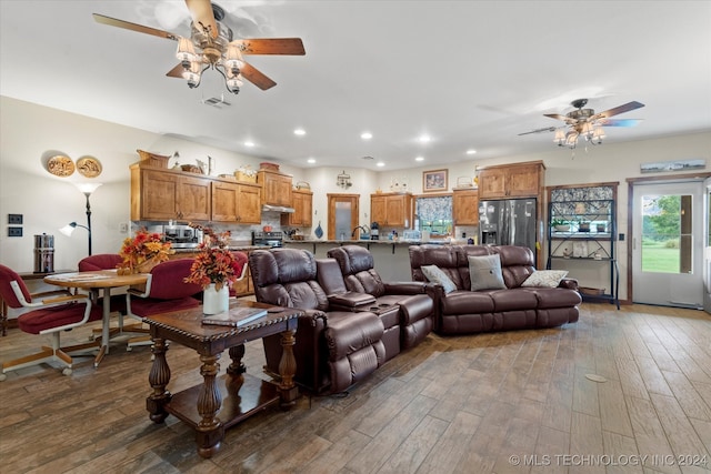 living room featuring ceiling fan and wood-type flooring