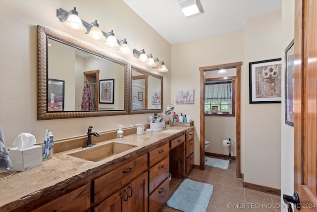 bathroom featuring vanity, toilet, and tile patterned flooring