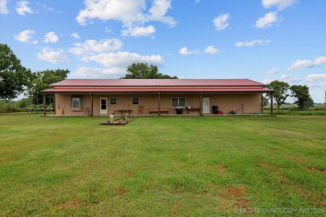 rear view of property with a yard