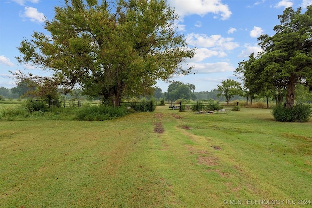 view of yard with a rural view and fence