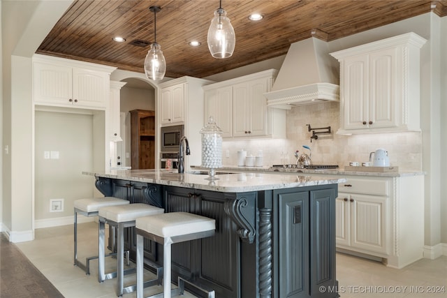 kitchen featuring white cabinetry, stainless steel appliances, light stone countertops, wooden ceiling, and custom range hood