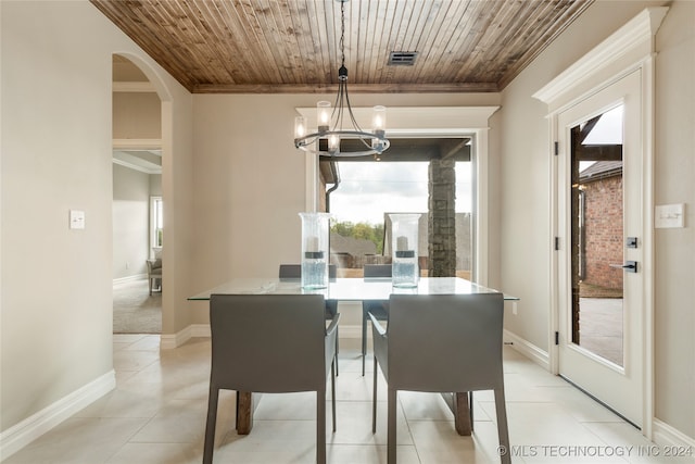 tiled dining room featuring wooden ceiling, ornamental molding, and a chandelier