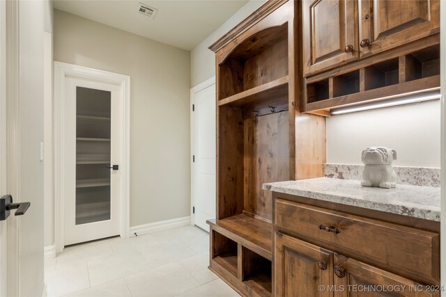 mudroom with light tile patterned floors