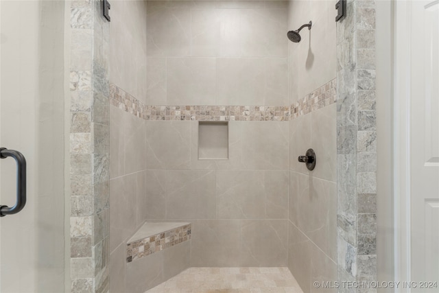 bathroom featuring a shower with shower door