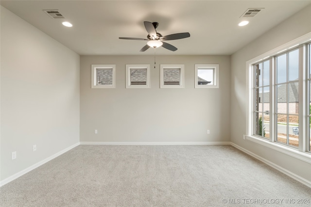 unfurnished room featuring ceiling fan and light carpet