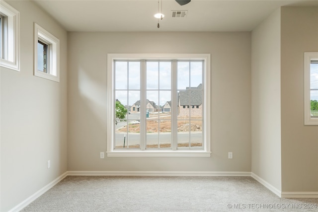 unfurnished room with ceiling fan and light colored carpet