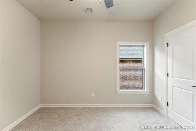 carpeted spare room with a healthy amount of sunlight and ceiling fan