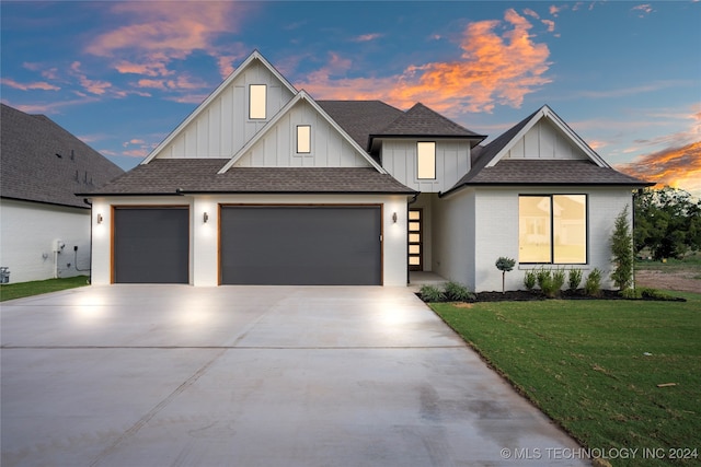 view of front of house with a lawn and a garage