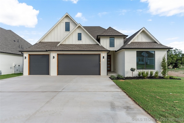 view of front of property featuring a garage and a front yard