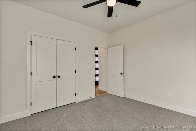 unfurnished bedroom with carpet flooring, ceiling fan, and a closet