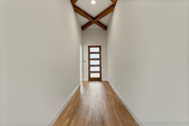 hallway featuring light hardwood / wood-style flooring and beam ceiling